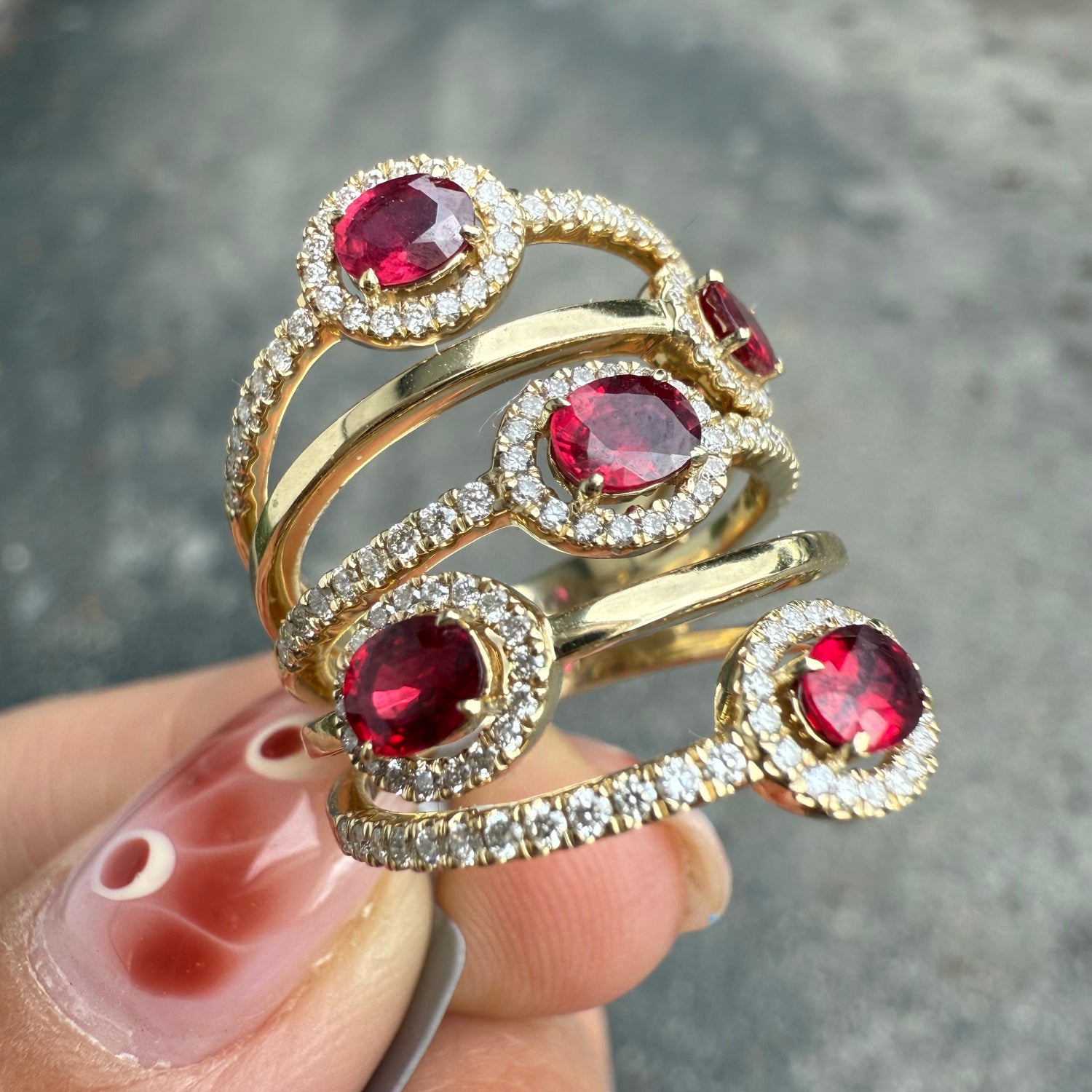 Ruby and diamond halo ring in 14K yellow gold, available at Santayana Jewelers Miami
