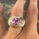 Heart shaped pink tourmaline mounted on a wide yellow gold band with stripe details. Designed by Miriam Santayana.