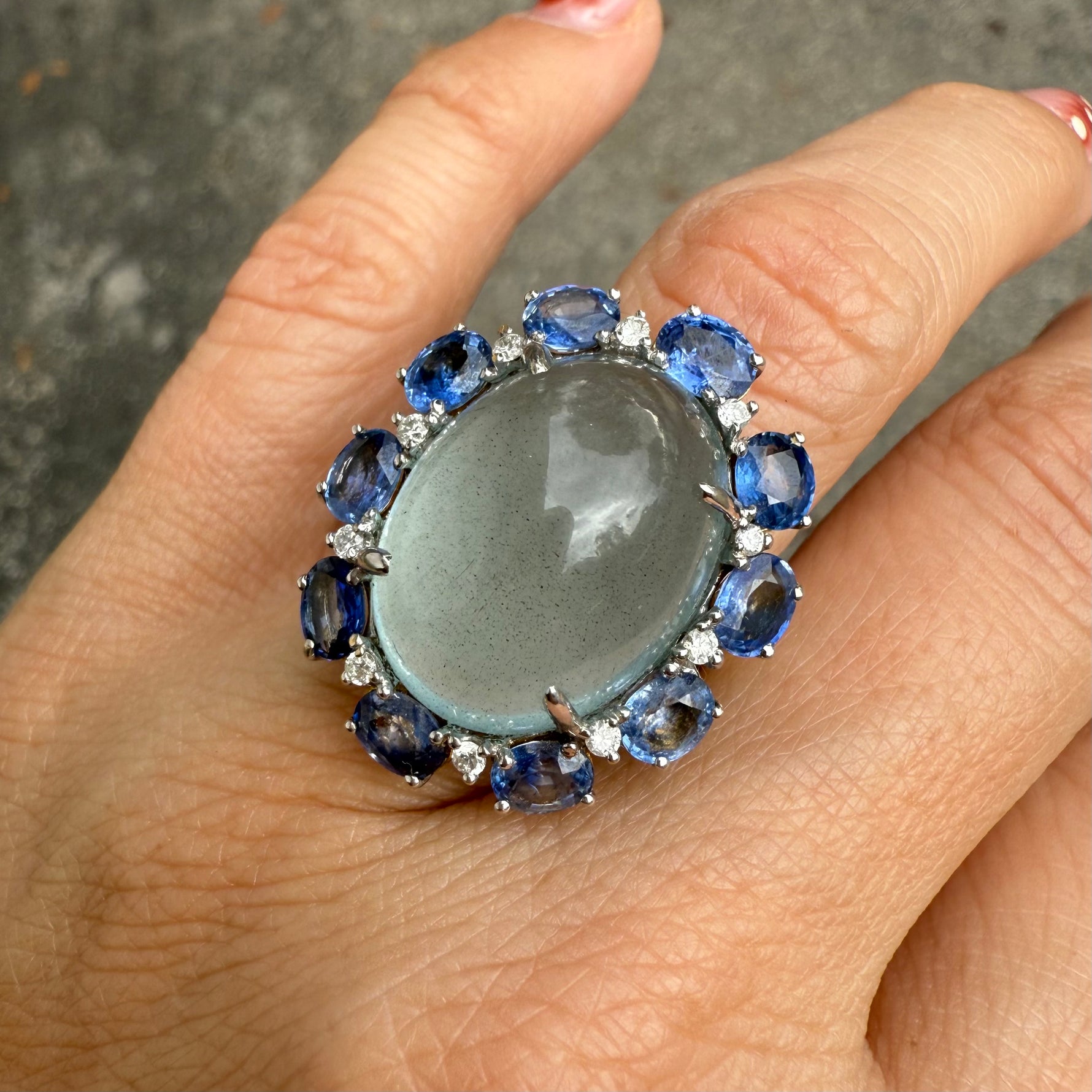 Oversized statement ring with 20 carat aquamarine cabochon, blue sapphires, and diamonds.