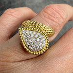 Hand view of textured 18K yellow gold diamond wrap ring, statement jewelry Miami