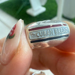 Silver bracelet charm of 'Cuban Bread'
