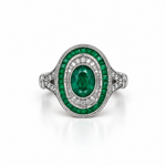 An oval emerald ring with 18k white gold pavé band, featuring a central emerald surrounded by round-cut diamonds.