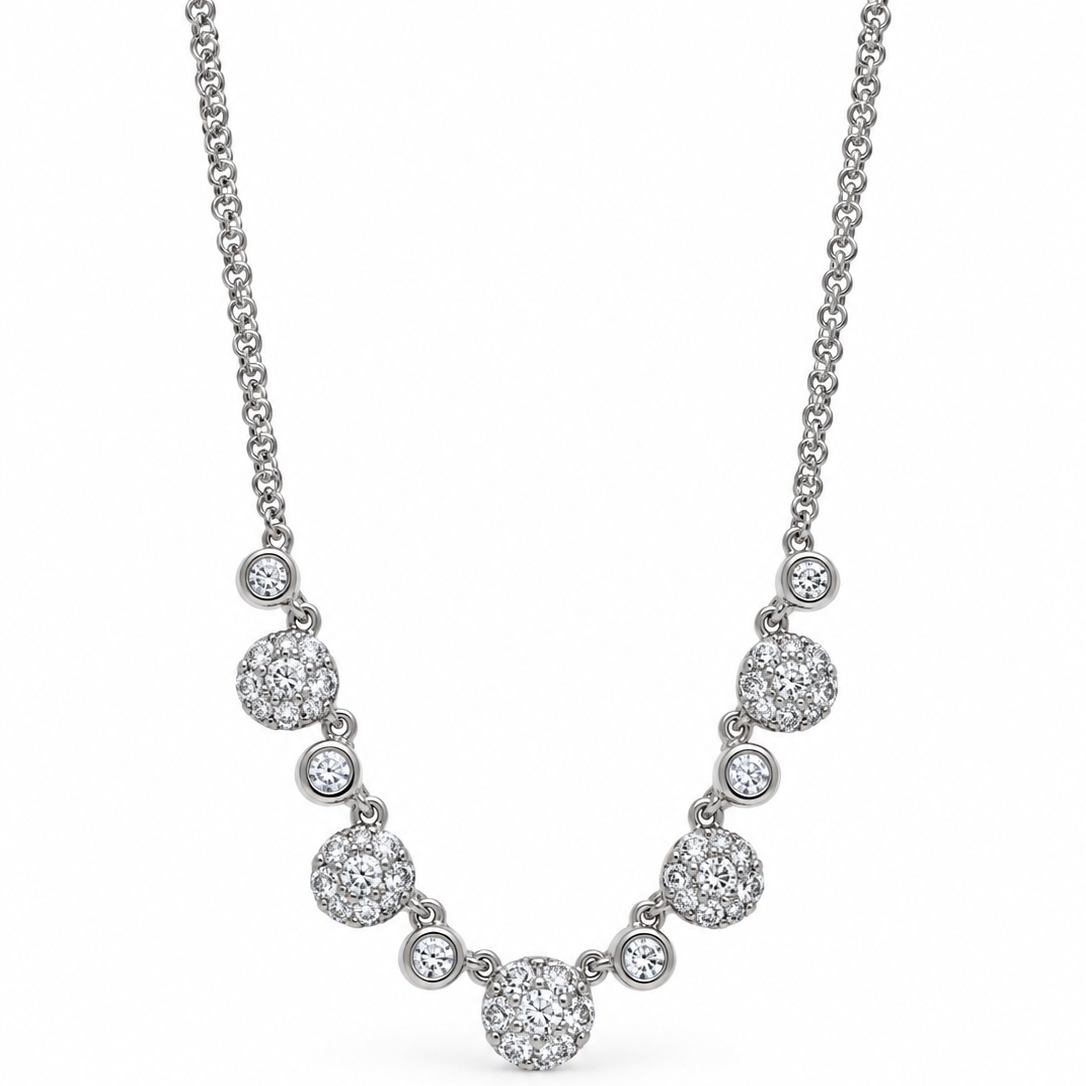 A white gold diamond necklace featuring a central round diamond pendant flanked by smaller round diamond clusters, suspended from a delicate double chain on a white background.