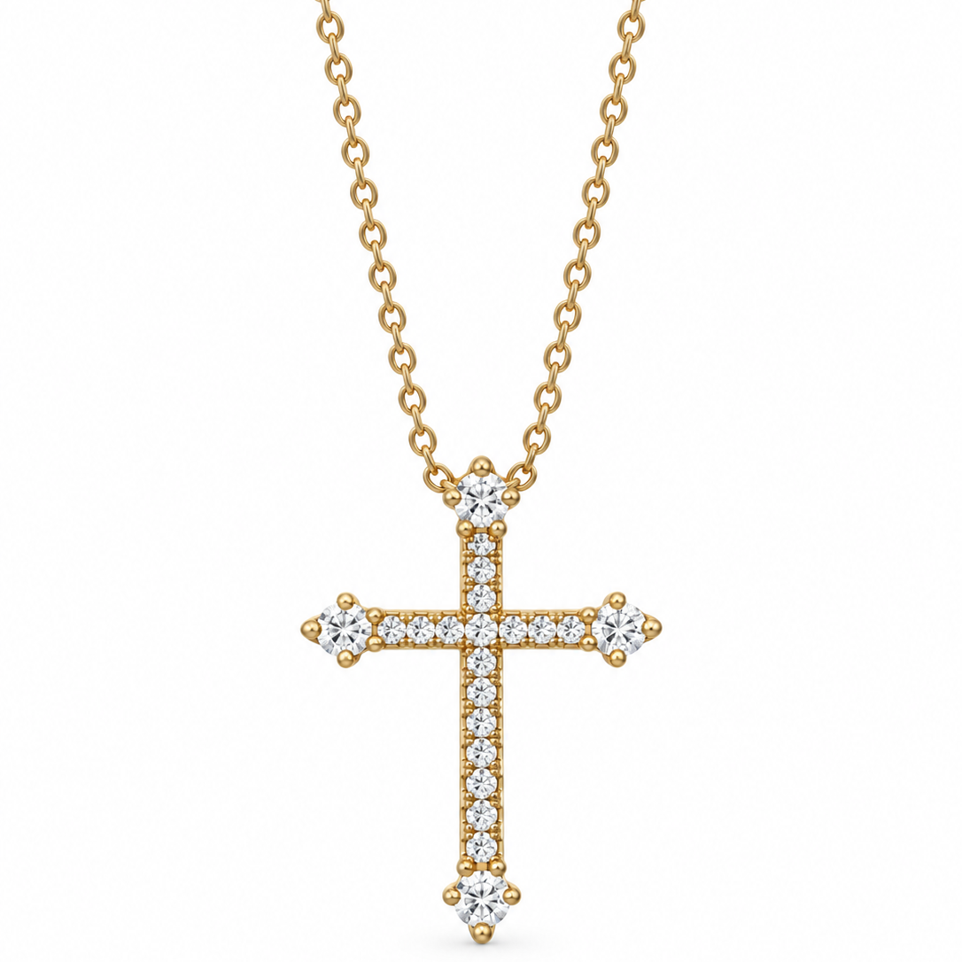 A gold cross pendant necklace adorned with diamonds, hanging from a delicate gold chain against a plain white background.