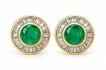 Round emerald and baguette diamond halo stud earrings in 14K yellow gold, 12.5 mm diameter, with push-back closures.