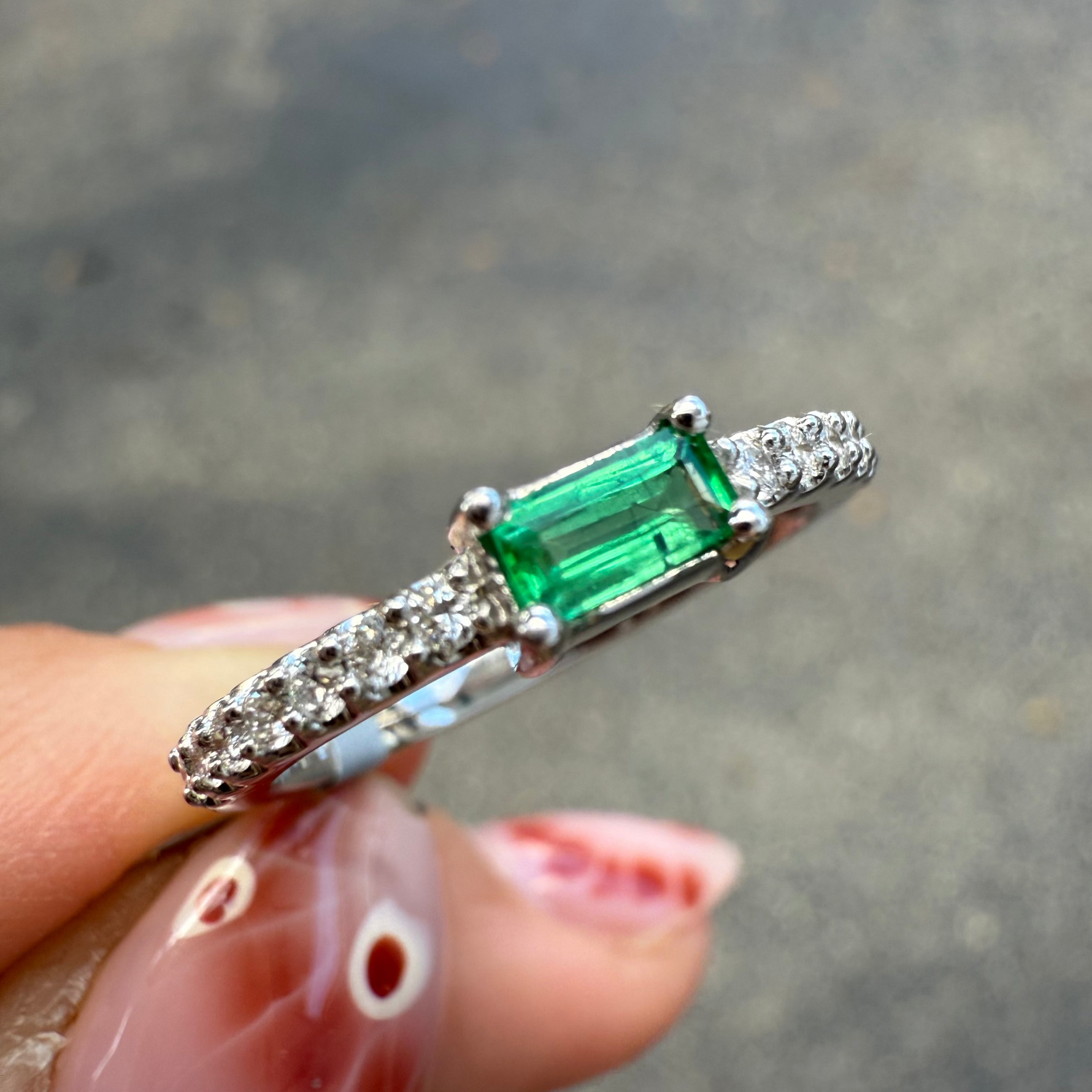 Dainty emerald and diamond ring in 14K white gold.