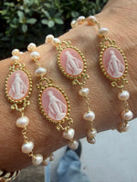 Stack of bracelets in Miami style of pink milagrosa virgencita bracelets