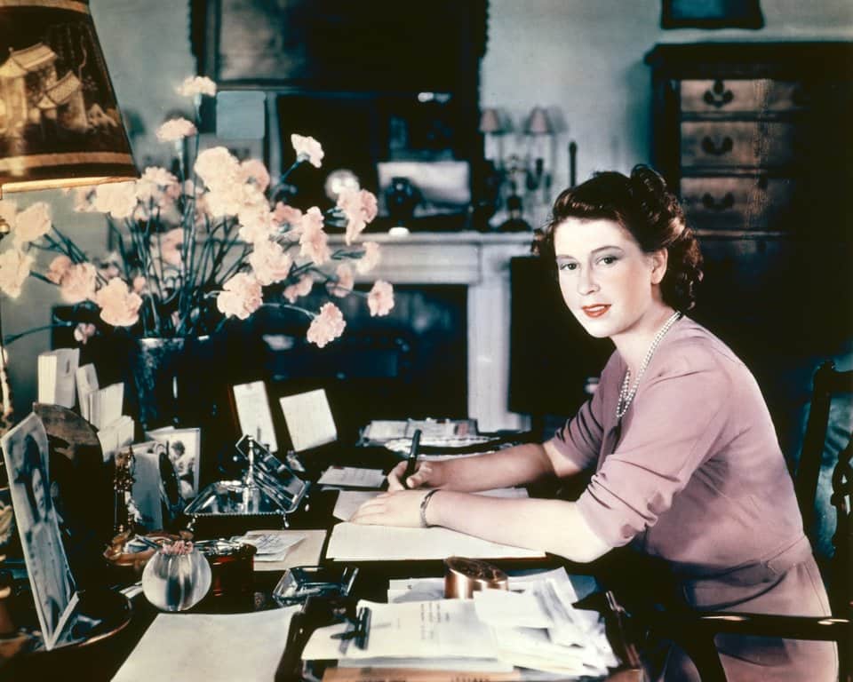 Princess Elizabeth (later Queen Elizabeth II) at her desk in her sitting room at Buckingham Palace