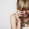 Beautiful blond laughing with gold necklace close up