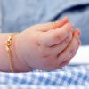 Baby hand with gold bracelet