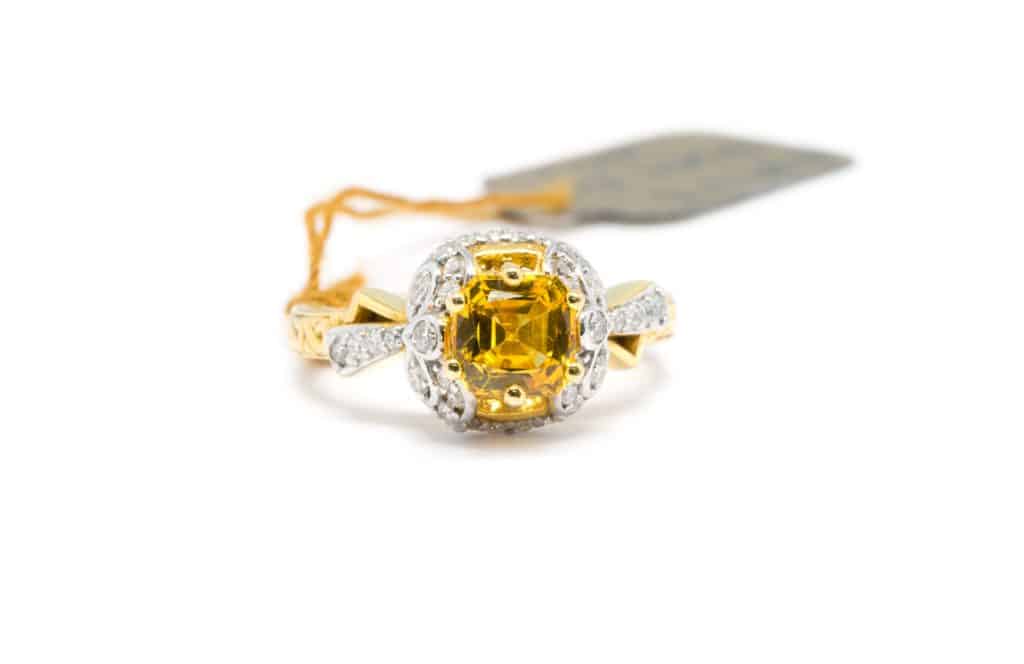 Gold ring with diamond and yellow sapphire isolated